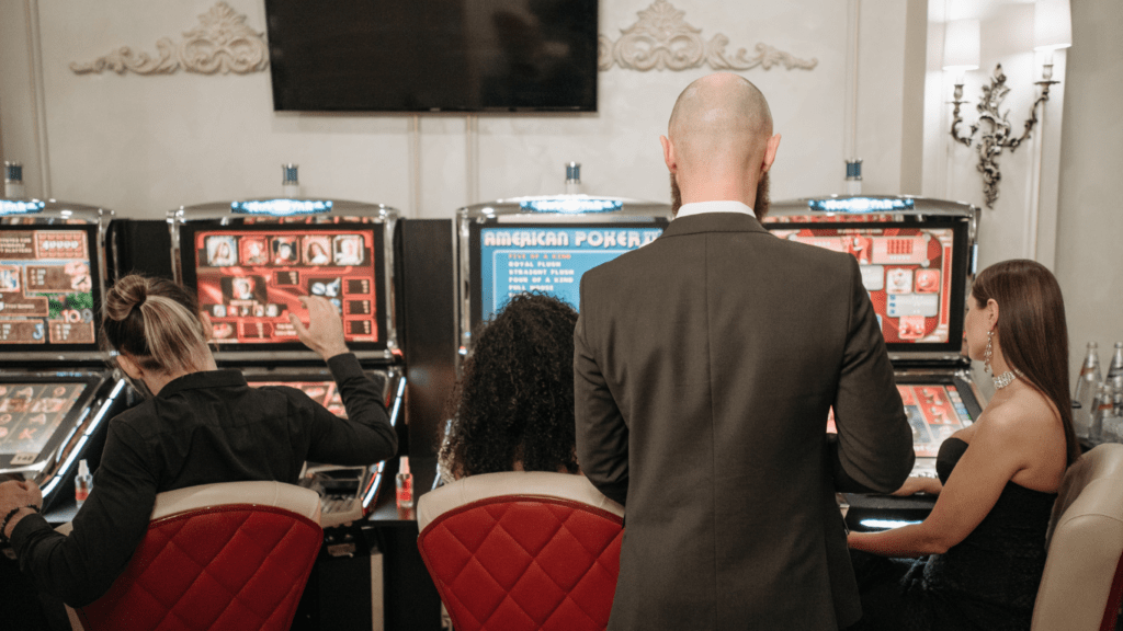 A person playing a slot machine in a casino