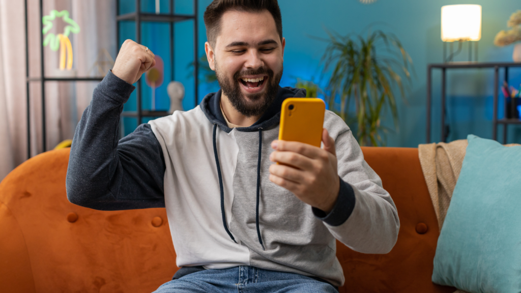 a person is sitting on a couch and holding up their phone