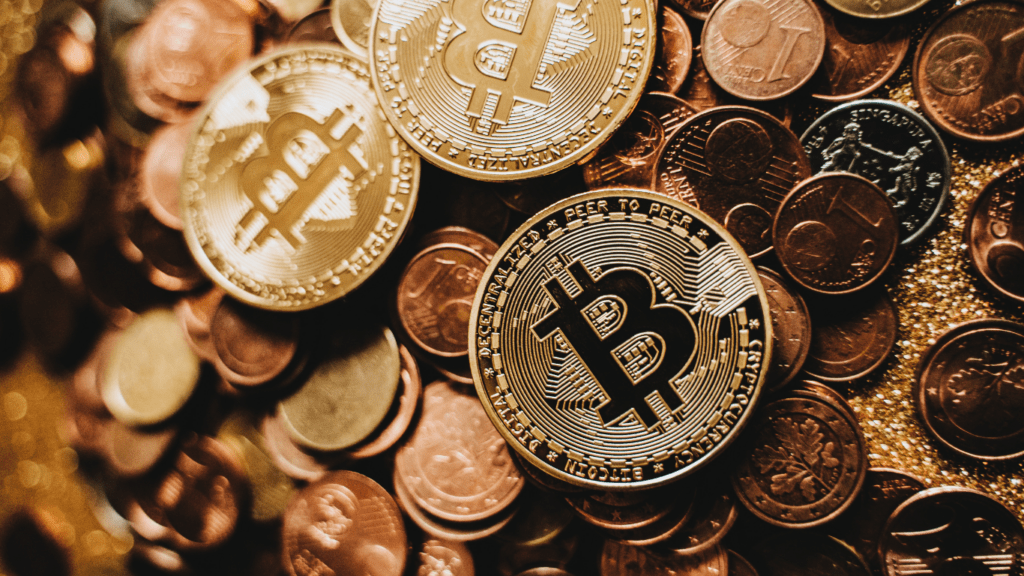 a pile of bitcoin coins on a gold background