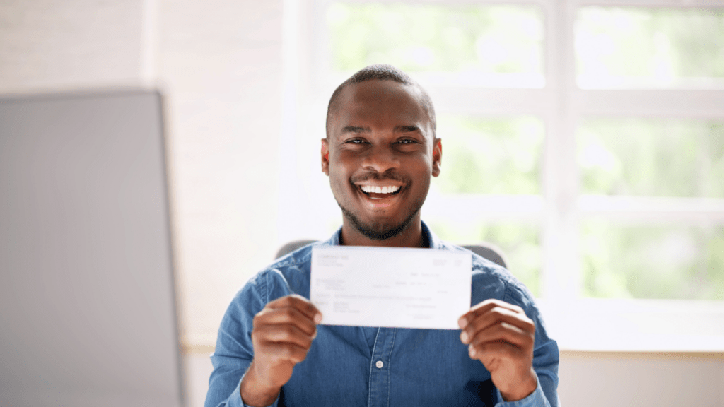 a person holding a cheque