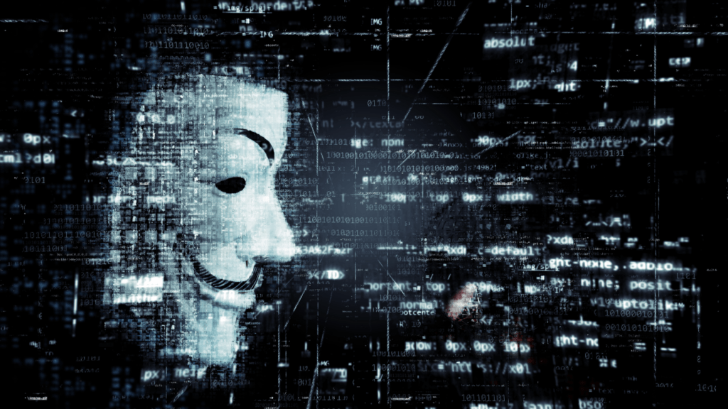 anonymous mask in front of a computer screen