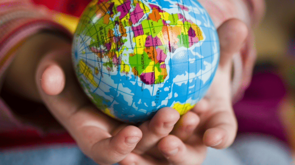 a child holding a globe in their hands