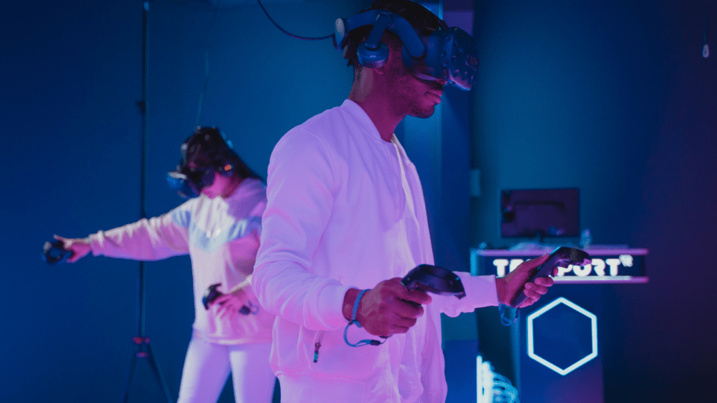 two people wearing virtual reality headsets in a room