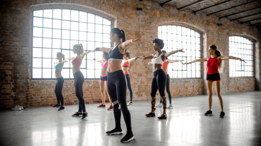 a group of people doing yoga in a gym