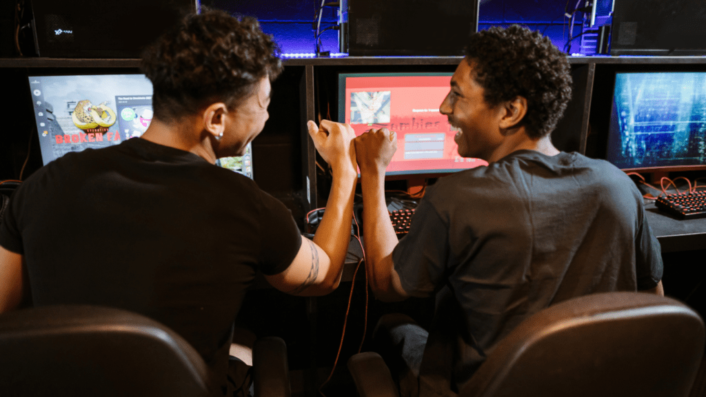 a group of people playing video games in a dark room