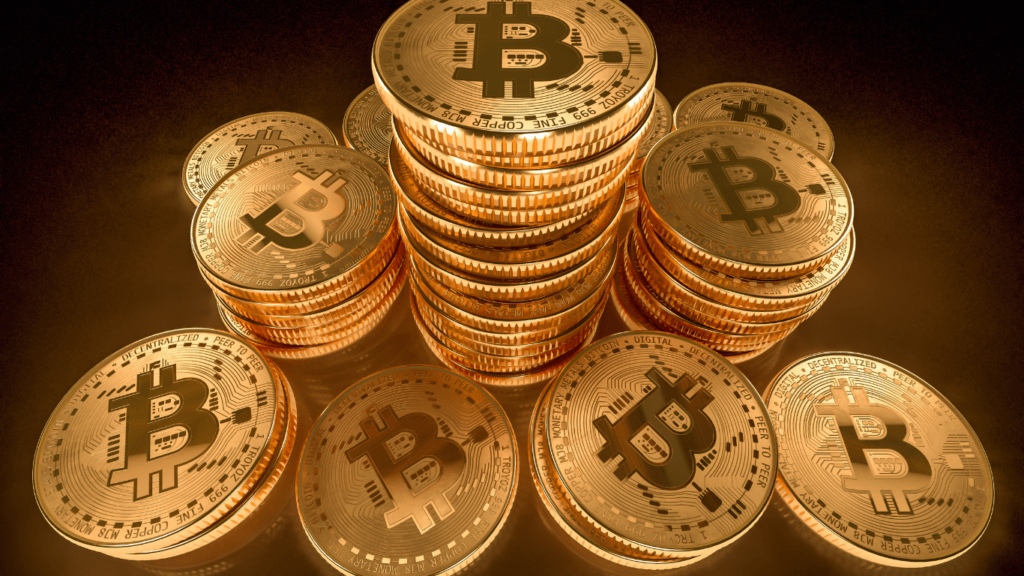 a pile of bitcoin coins on a gold background