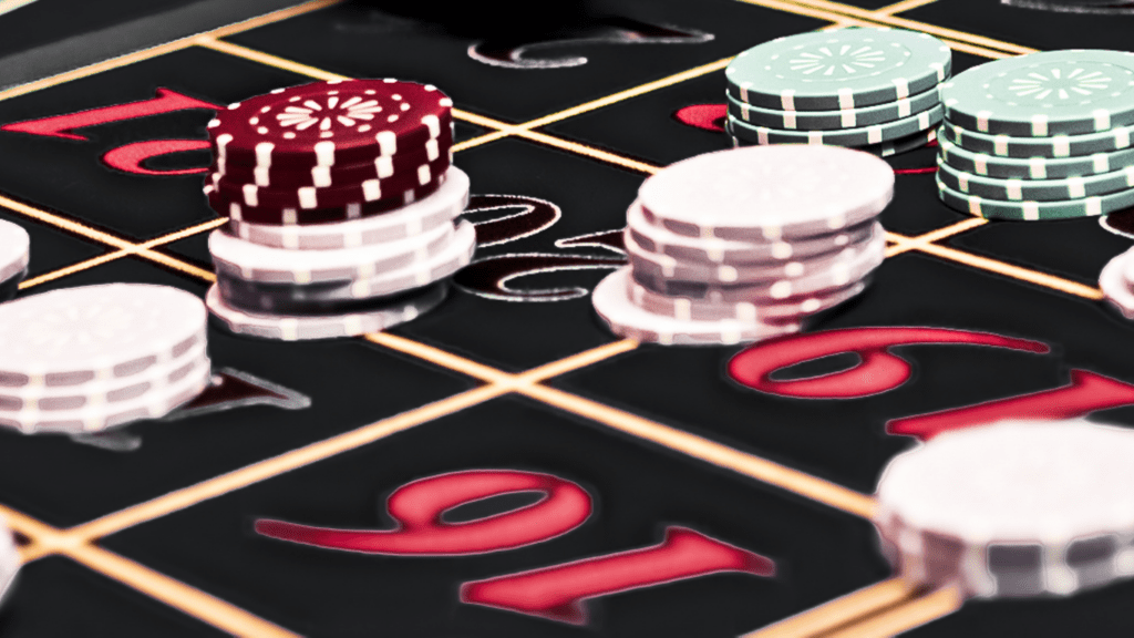 an image of a casino table with chips and roulettes