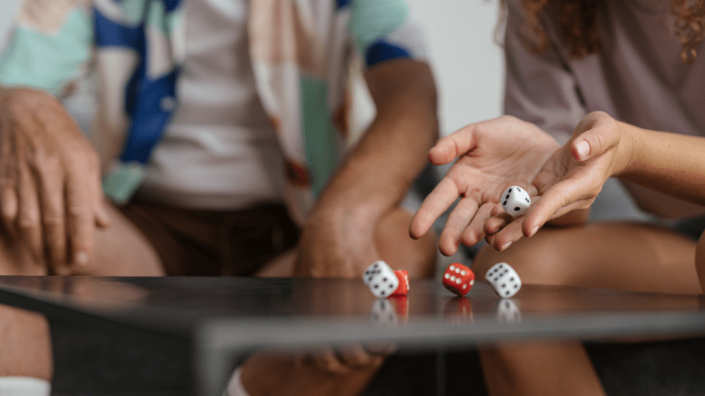 people playing dice on a table